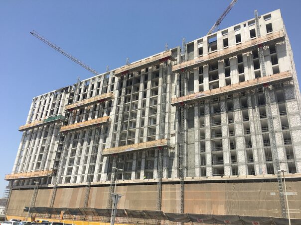 multiple large mast climbers on the side of a building